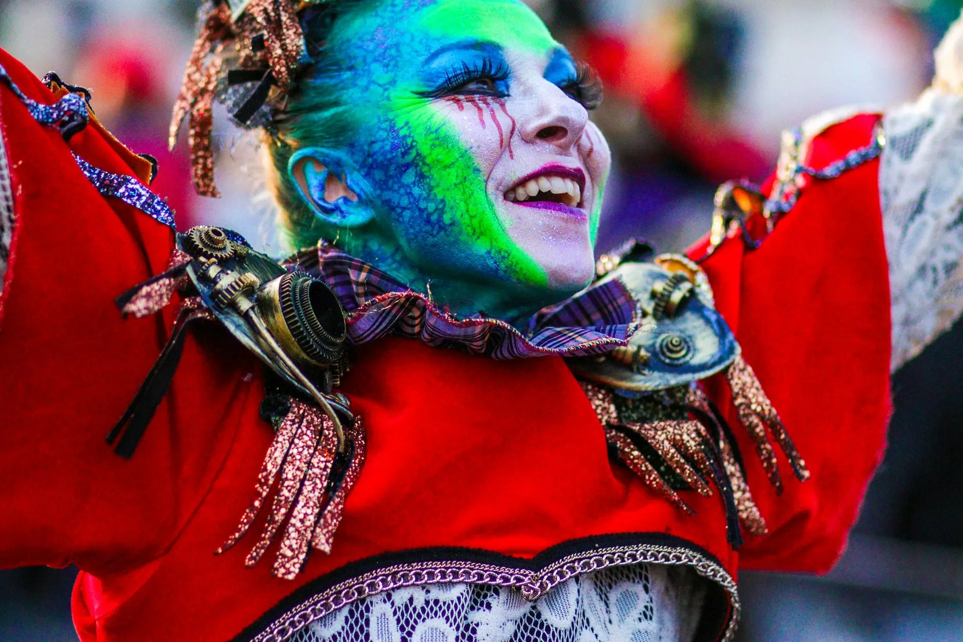 a woman with green face paint and blue hair