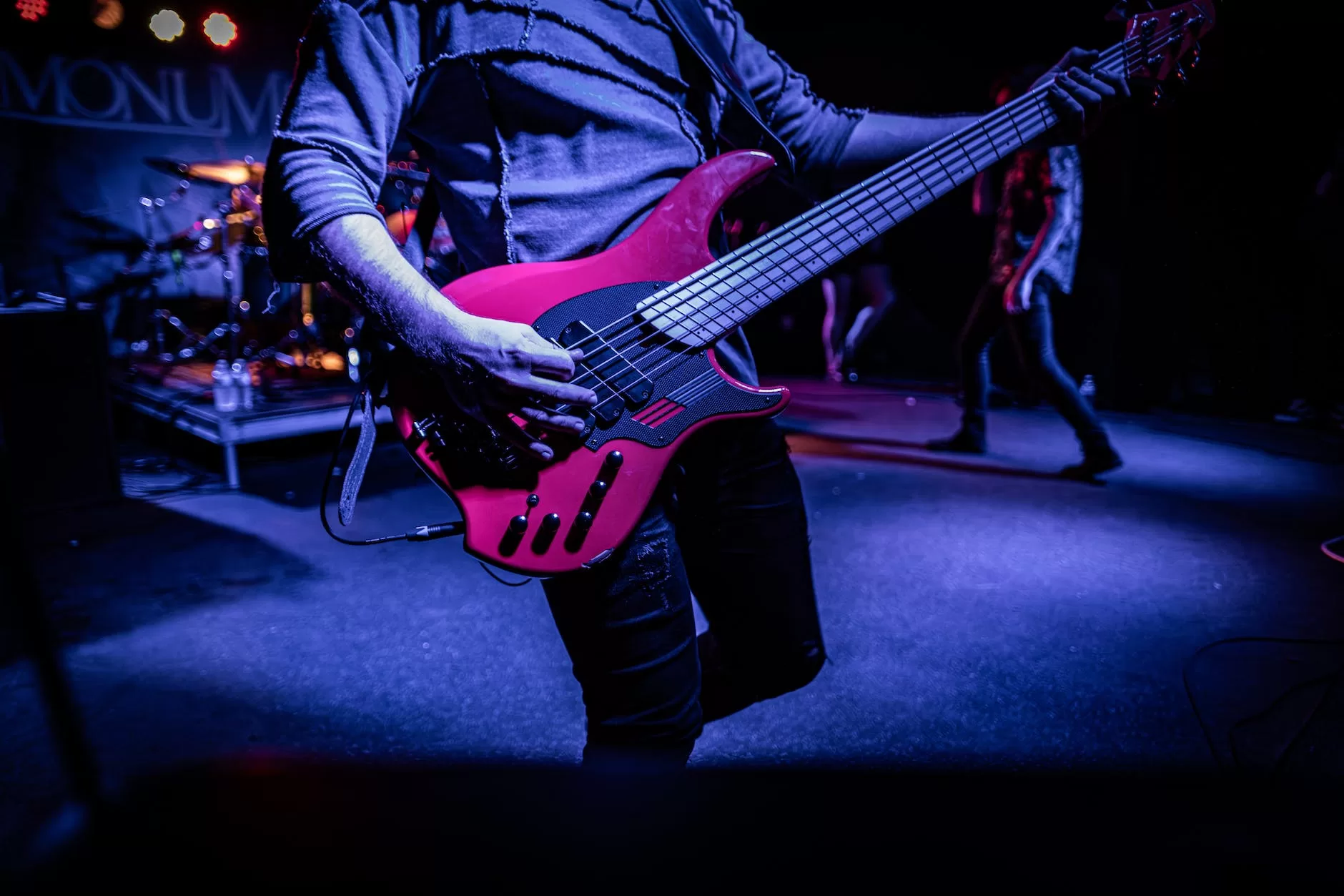 a man playing a bass guitar on stage