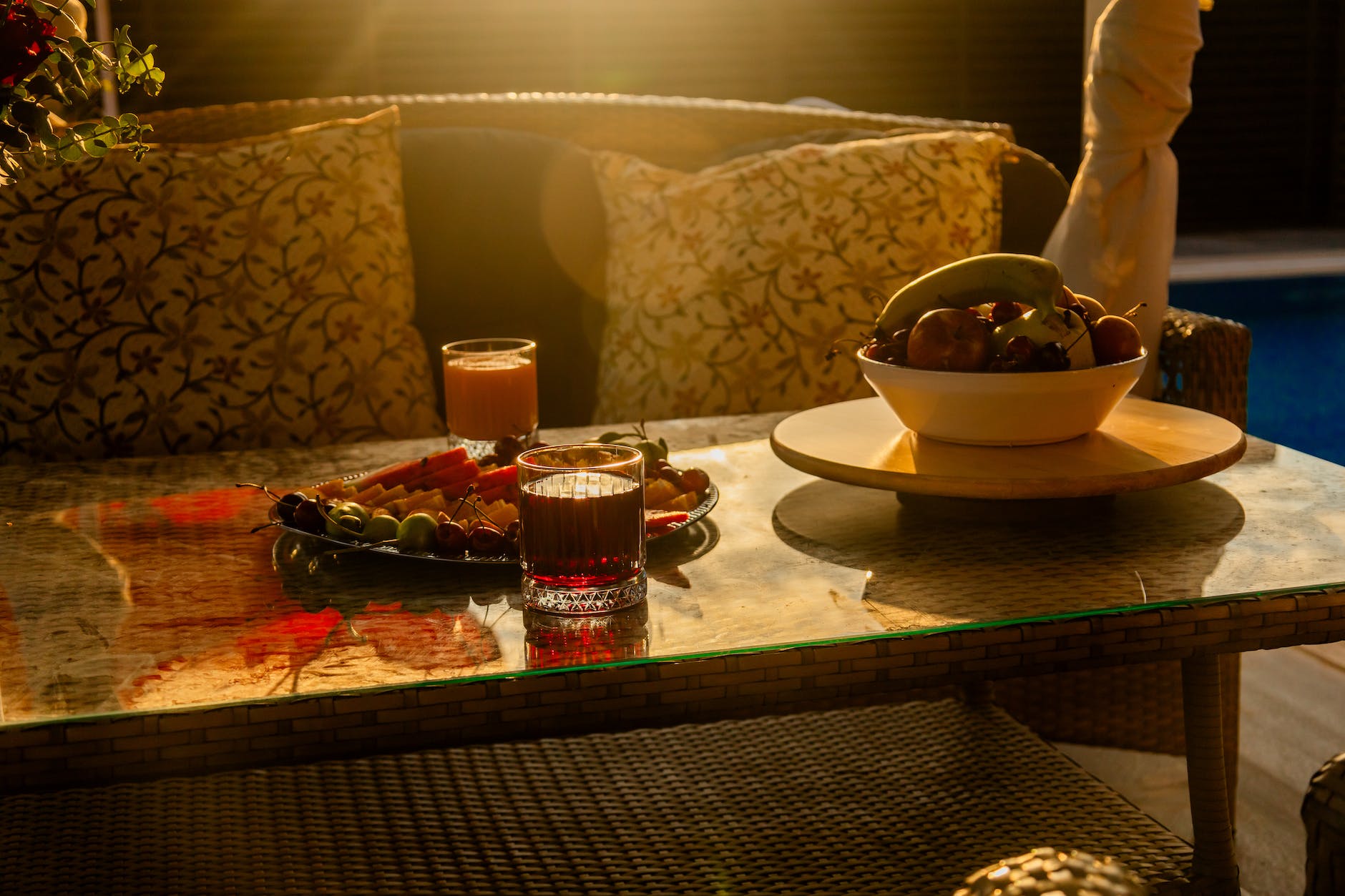 glasses with juice and fruit on the patio table