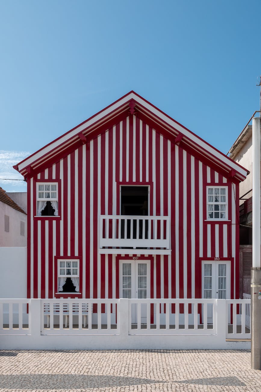 red and white wooden house under blue sky