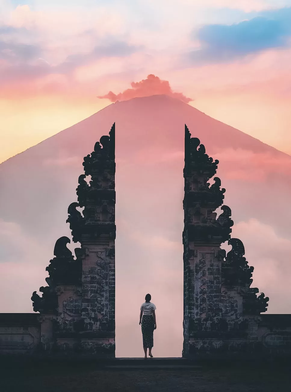 photo of person standing on a famous temple Indonesia Digital Nomad Visa
