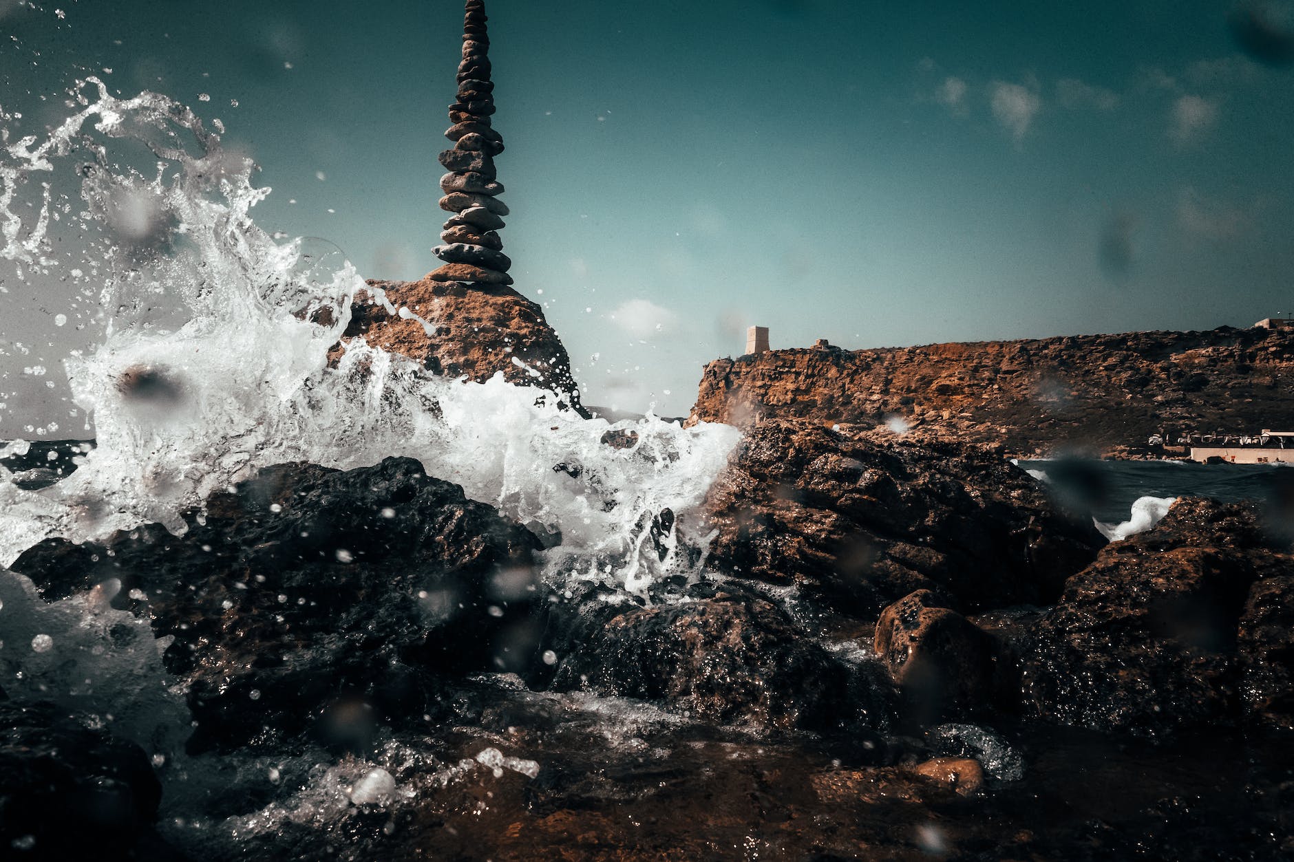 ocean water splashing on rocks Malta Digital Nomad Visa