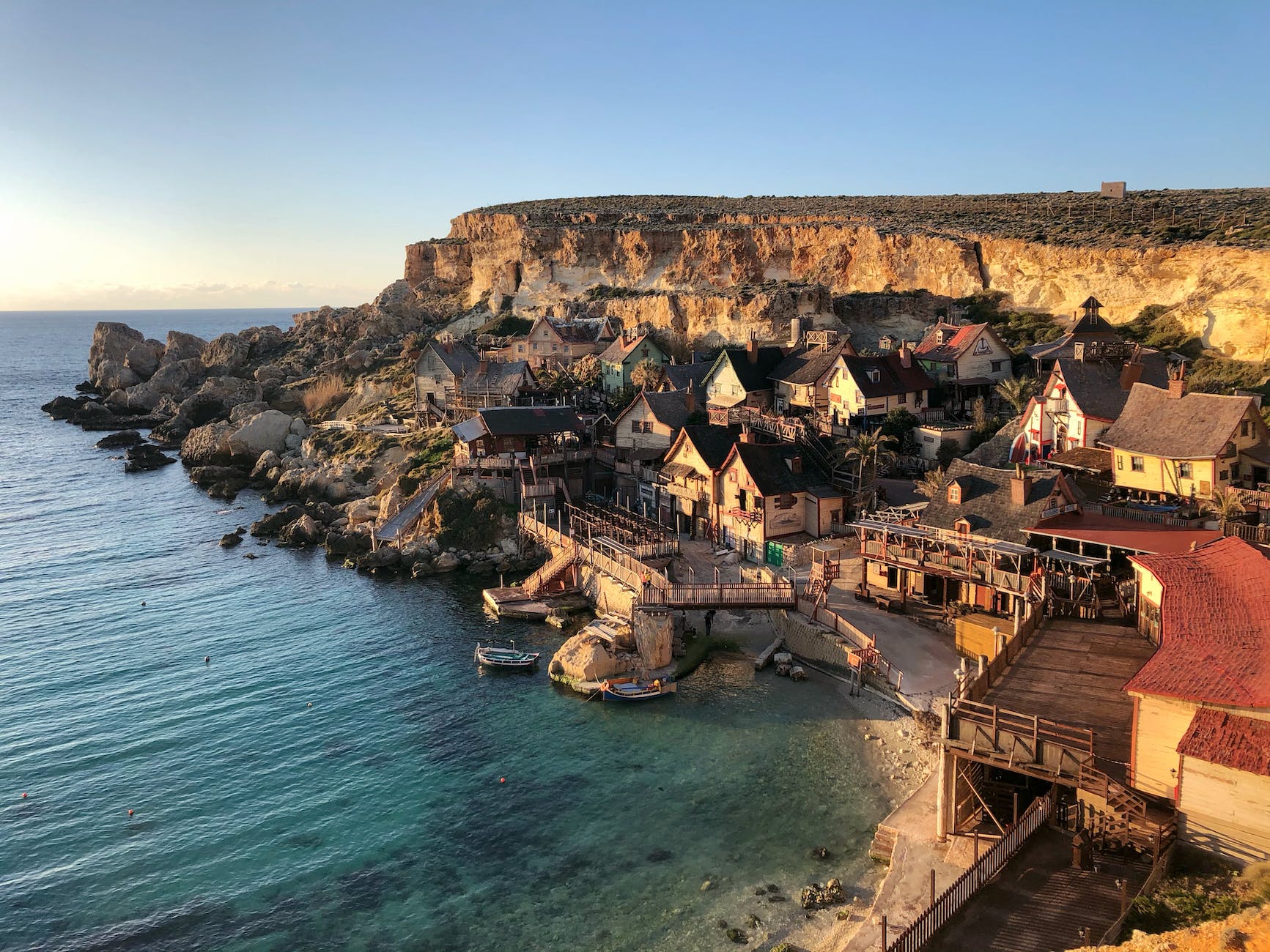 wide angle photography of buildings beside seashore