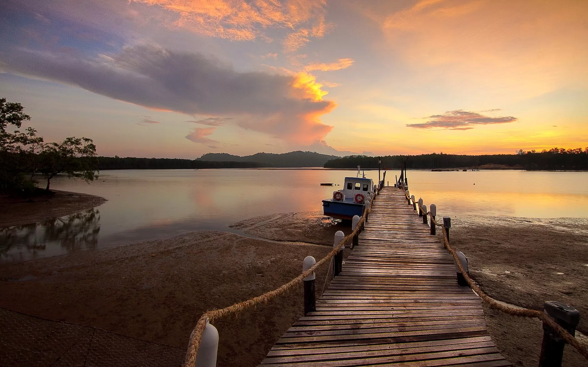 white boat beside wooden dock