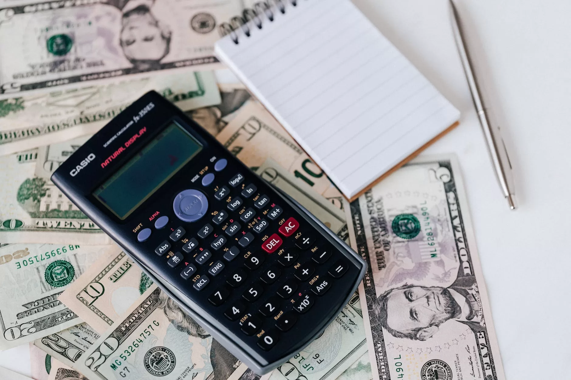 calculator and notepad placed on usa dollars stack Barbados Digital Nomad Visa