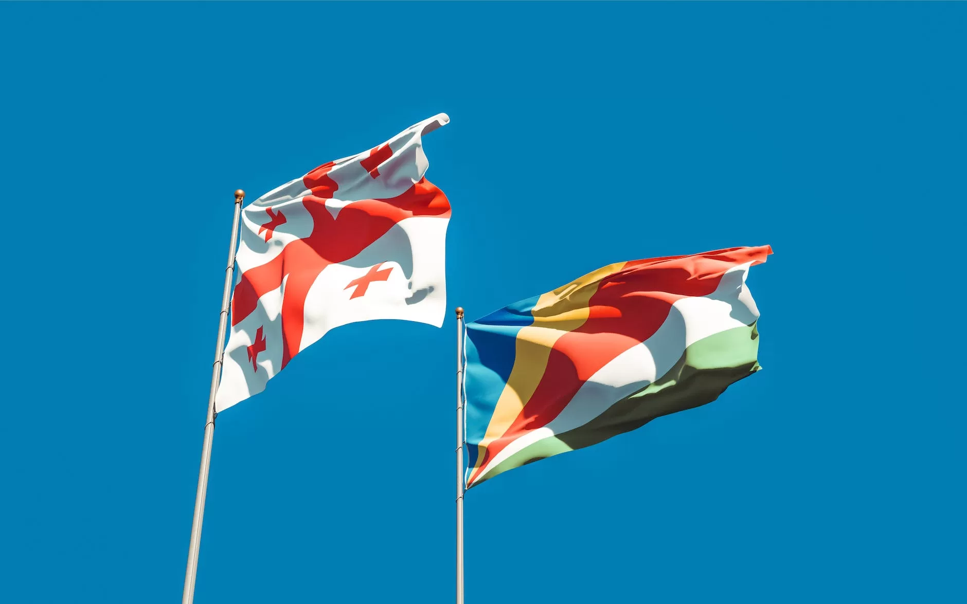 hanging flag of georgia beside the seychelles flag