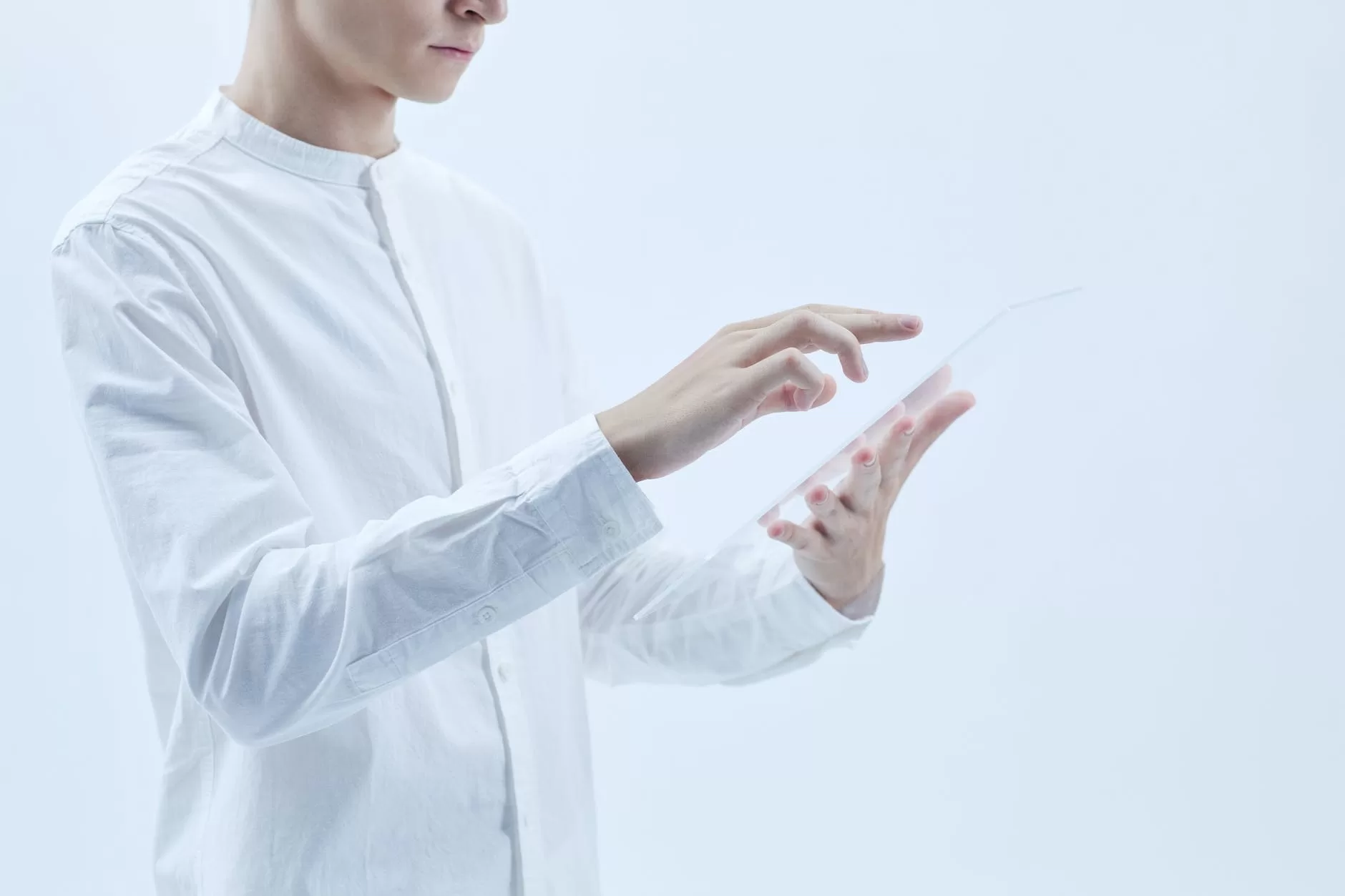 a person in white long sleeves holding a clear glass