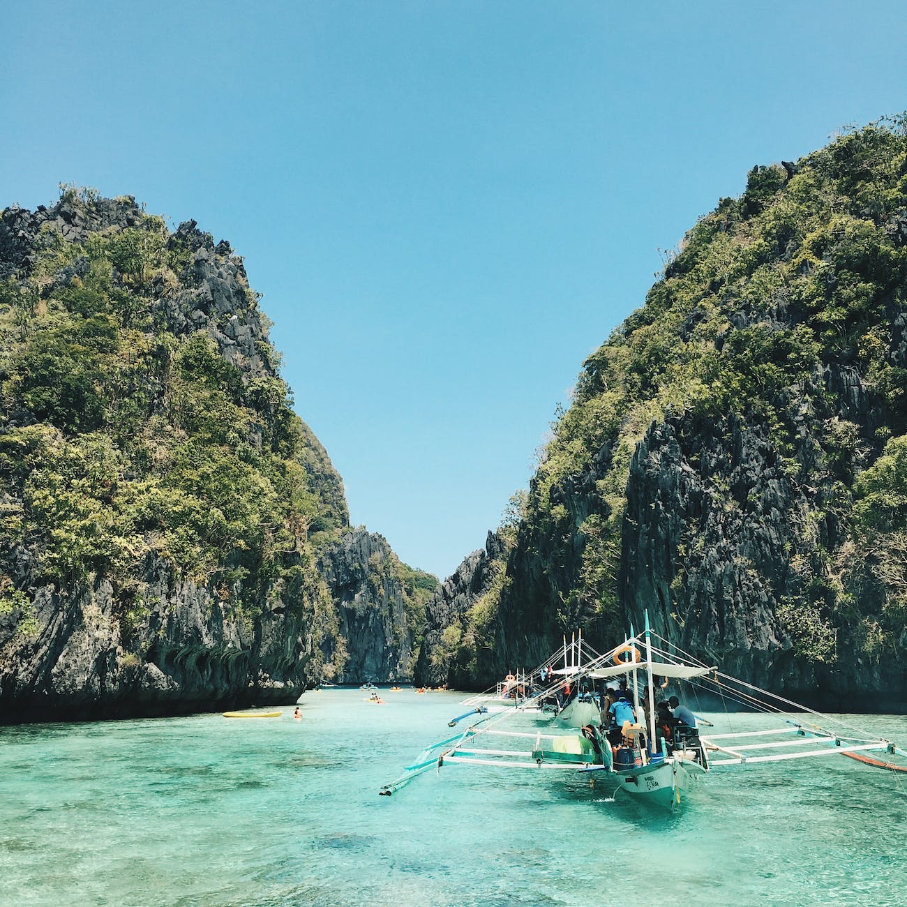 white and green sail boat in Southeast Asia