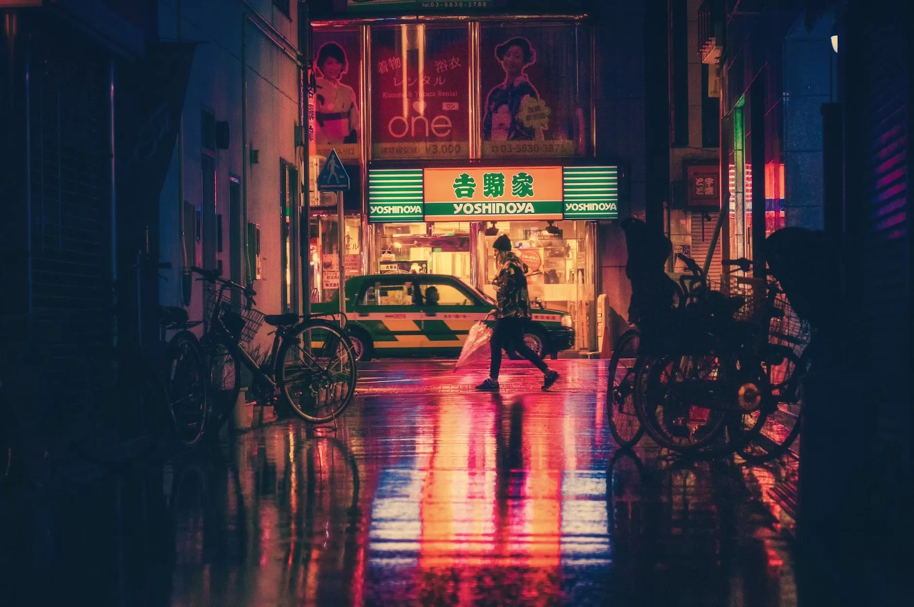 side view of woman in illuminated city at night in Asia
