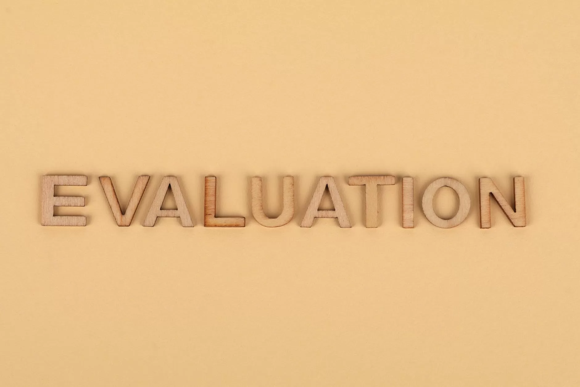 the word evaluation from wooden letters