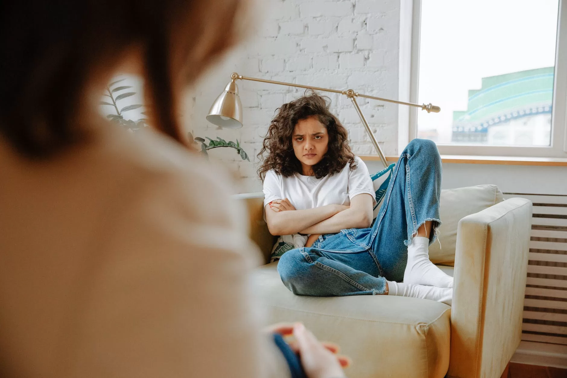 upset woman listening to therapist about Travel denial