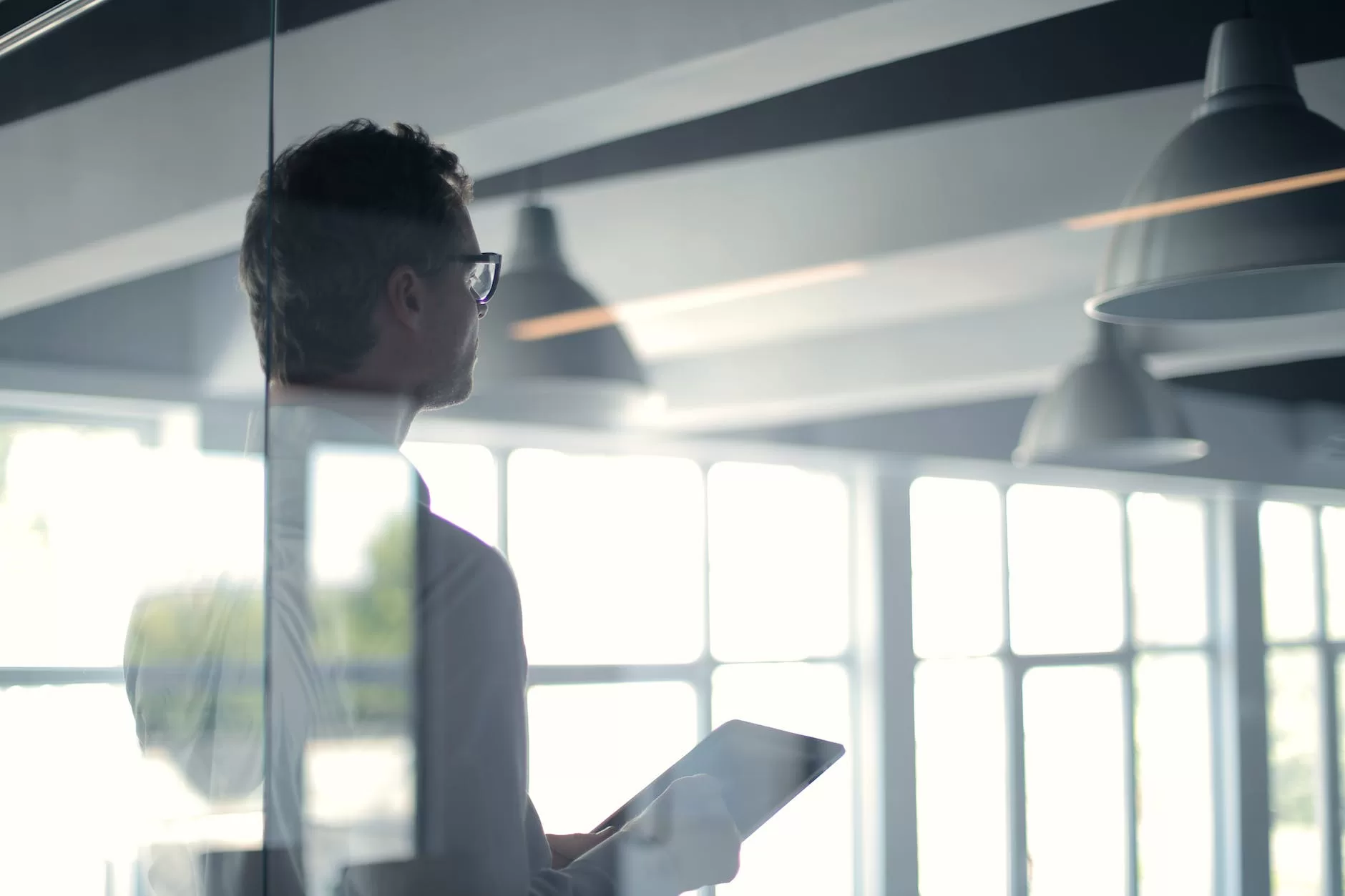 formal man with tablet giving presentation in office how to use points and miles to get cheap flights