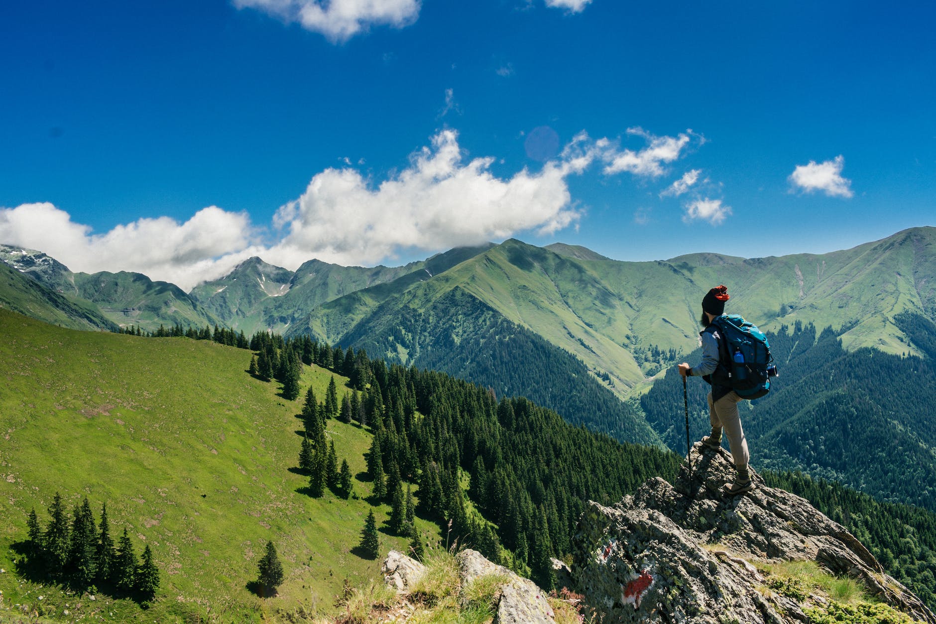 man standing on a rock with best carry on luggage 2024