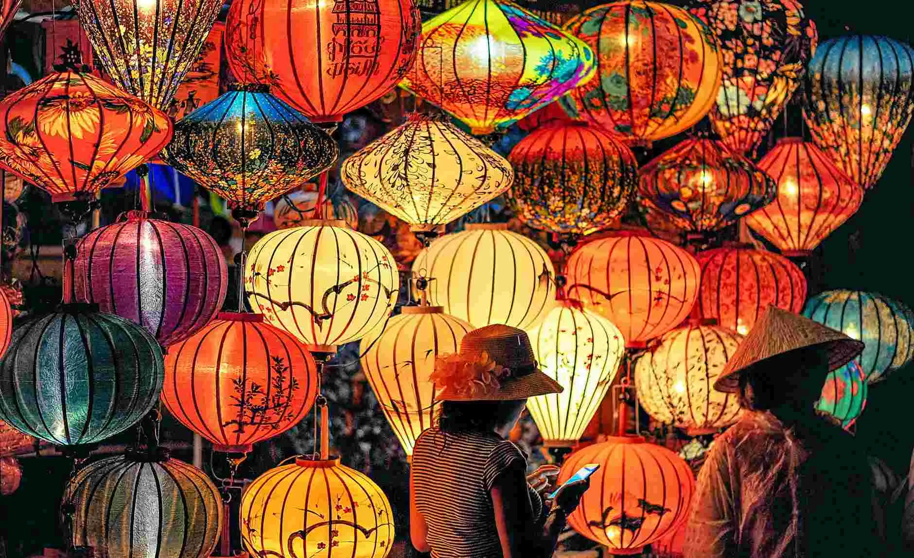 two person standing near assorted color paper lanterns