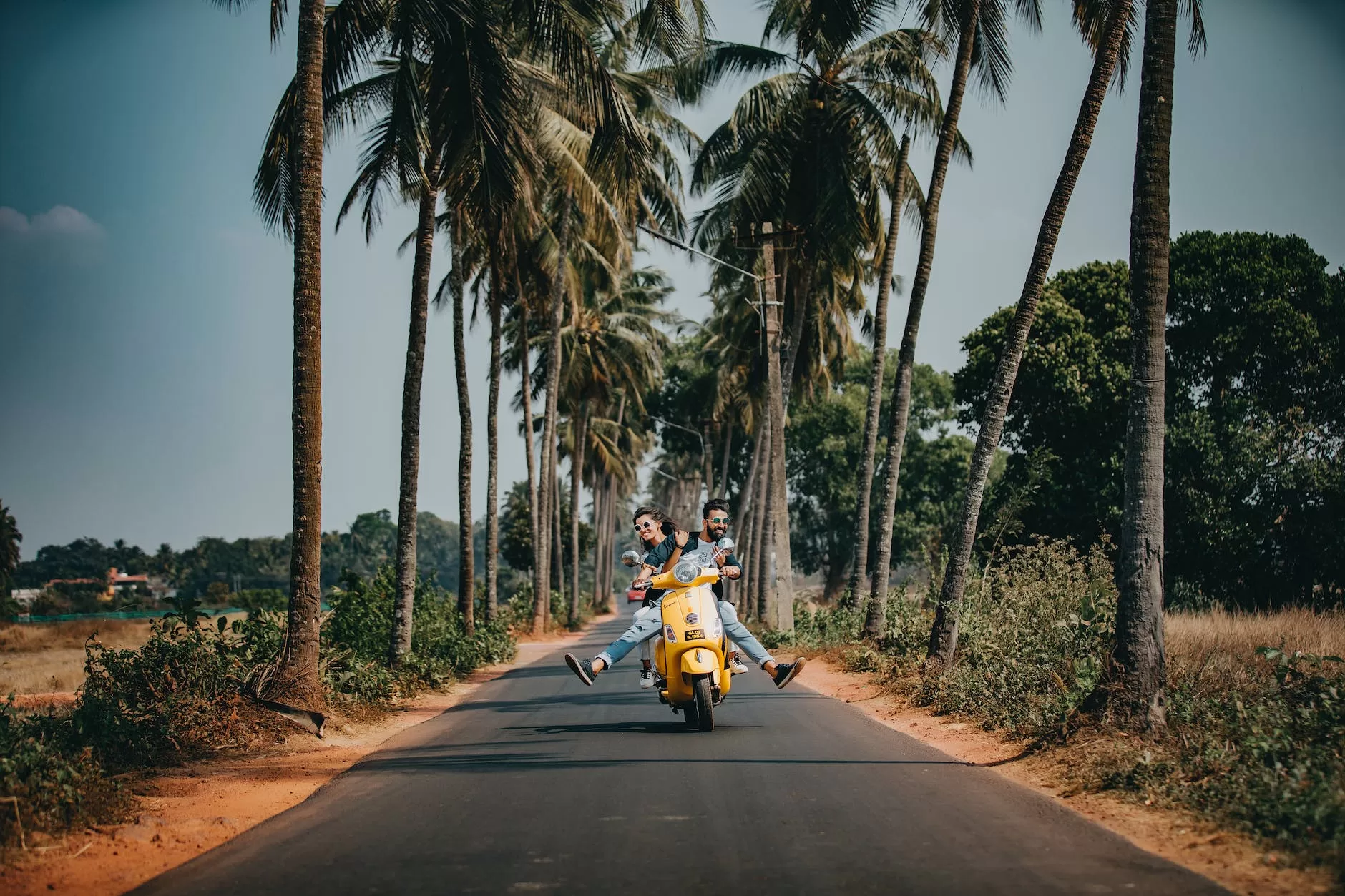 woman and man riding on motorcycle should get travel insurance