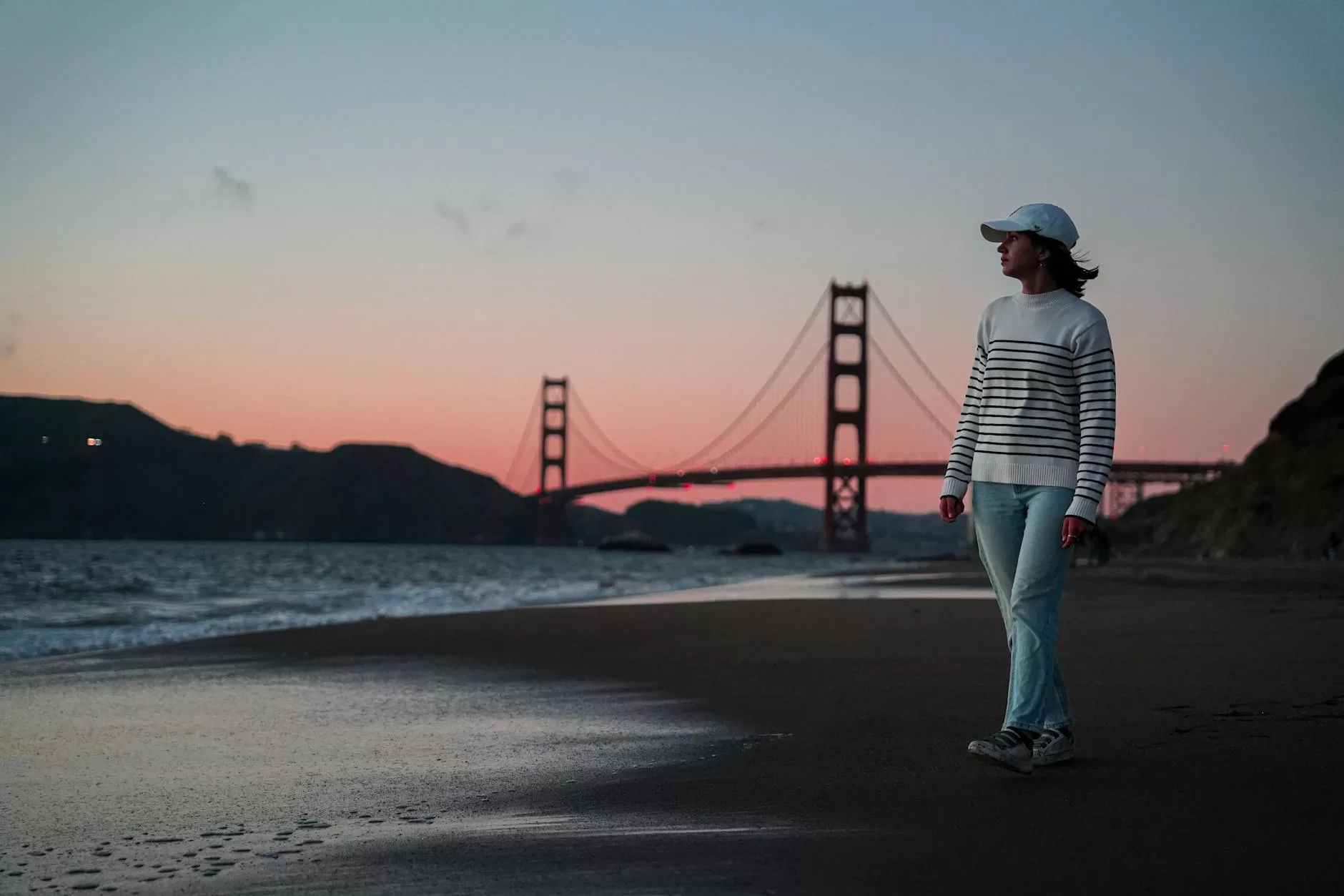 tourist walking on baker beach in san francisco at dusk solo female travel