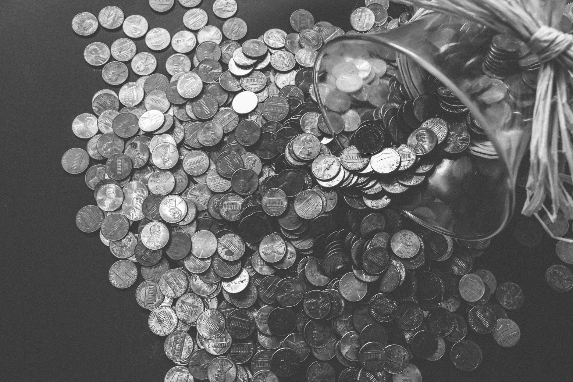 grayscale photo of coins to save when planing for a trip