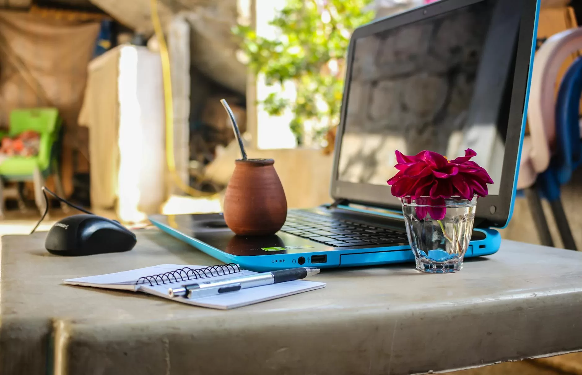 white notebook beside blue laptop computer