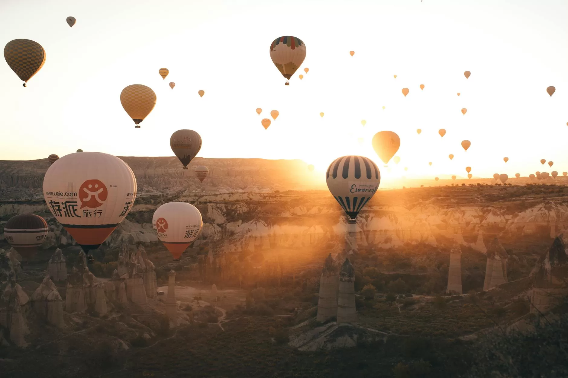 scenic view of hot air balloons flying in cappadocia at sunset