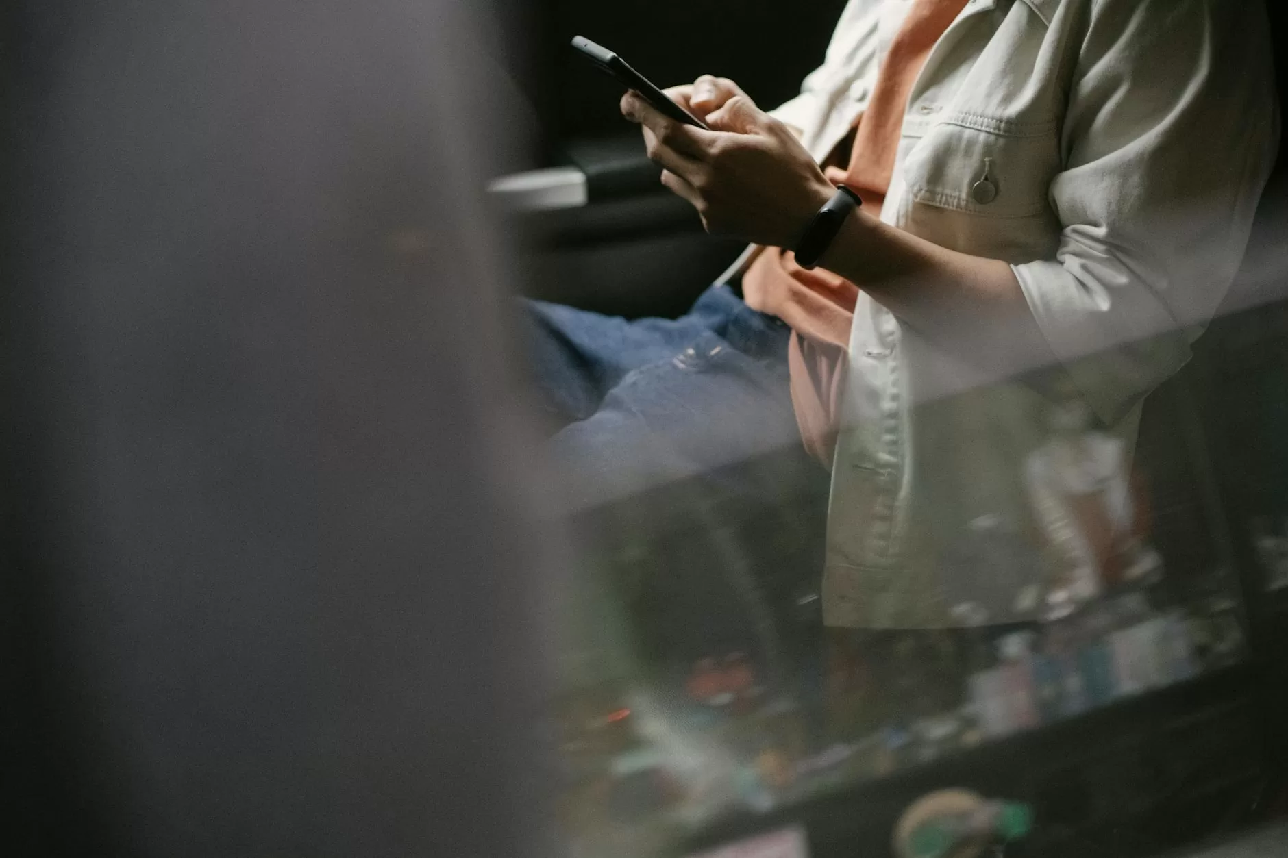 crop man messaging on smartphone while sitting in car