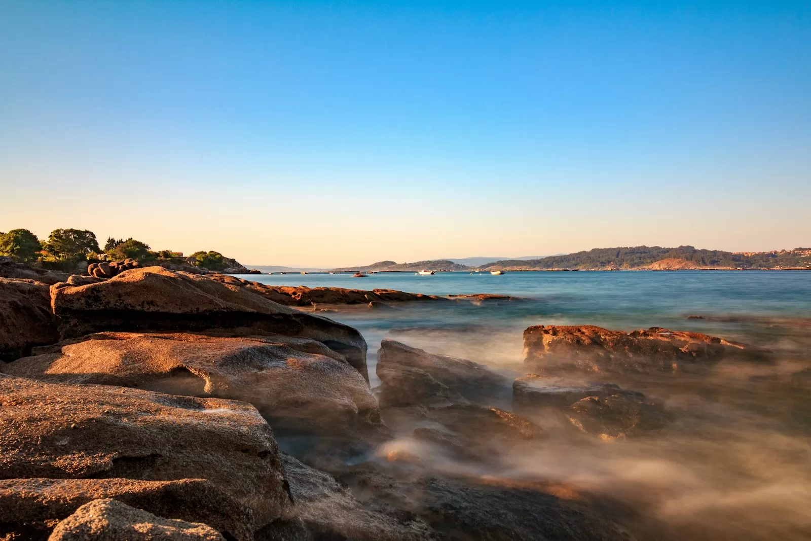 brown rocky shore under blue sky during daytime