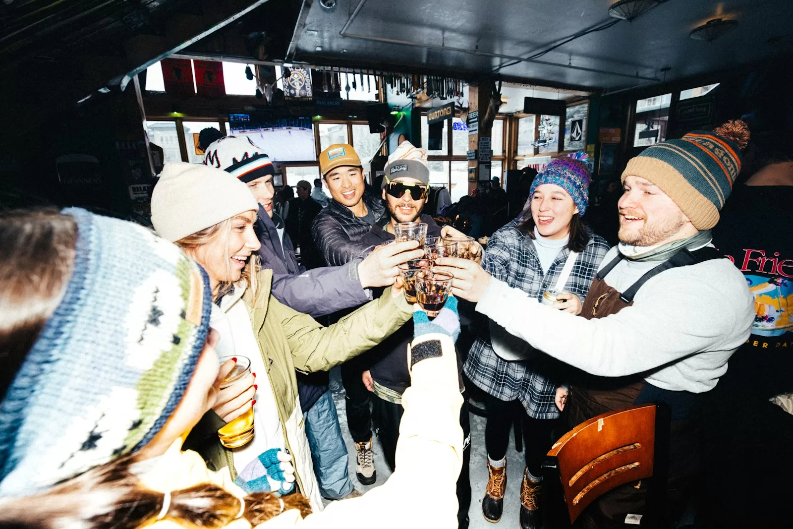 Friends make a celebratory toast in a bar.